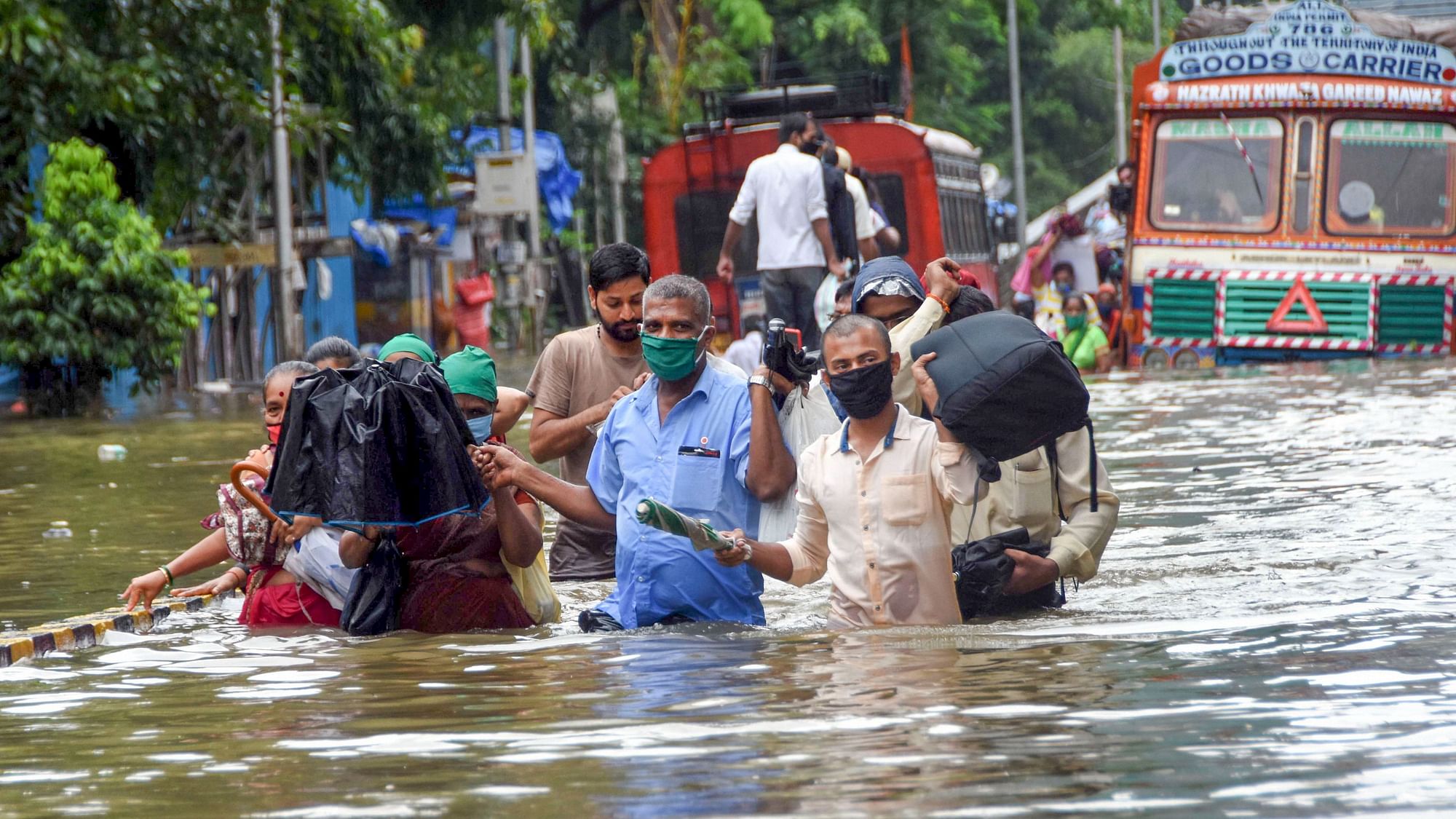 People wade through a waterlogged street at Parel area, after heavy monsoon rain, in Mumbai, Wednesday, 23 September, 2020.