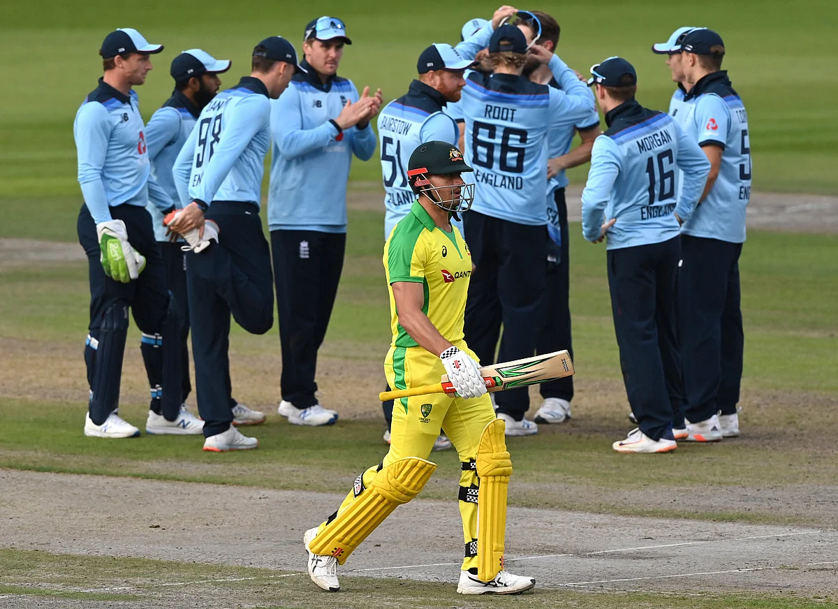 Manchester : Australia’s Marcus Stoinis, front, walks off the field after losing his wicket during the third ODI cricket match between England and Australia, at Old Trafford in Manchester, England, Wednesday, Sept. 16, 2020.