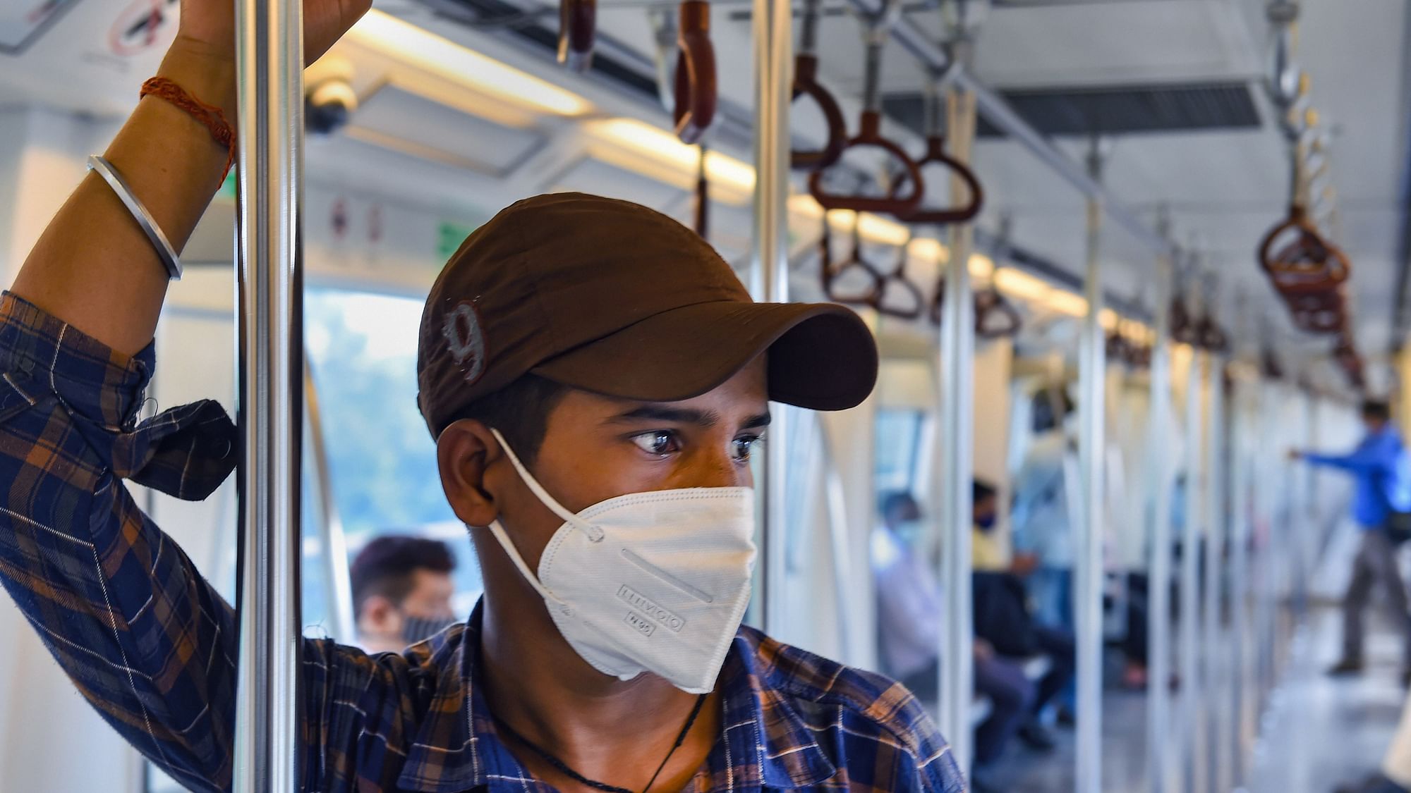 Commuters travel in a train after Delhi Metro resumed services with curtailed operation of the Yellow Line and Rapid Metro, amid the ongoing coronavirus pandemic, in New Delhi.