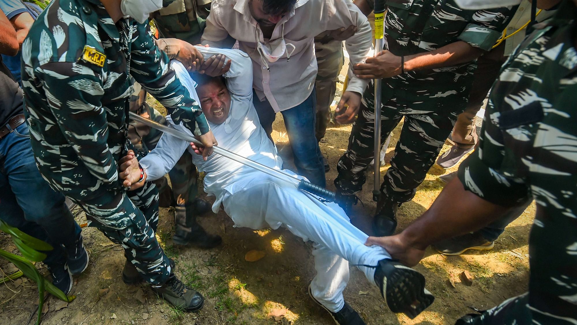 Delhi Police personnel detain Indian Youth Congress President BV Srinivas during a protest against the Central Government over farm bills in New Delhi, Tuesday, 22 September.