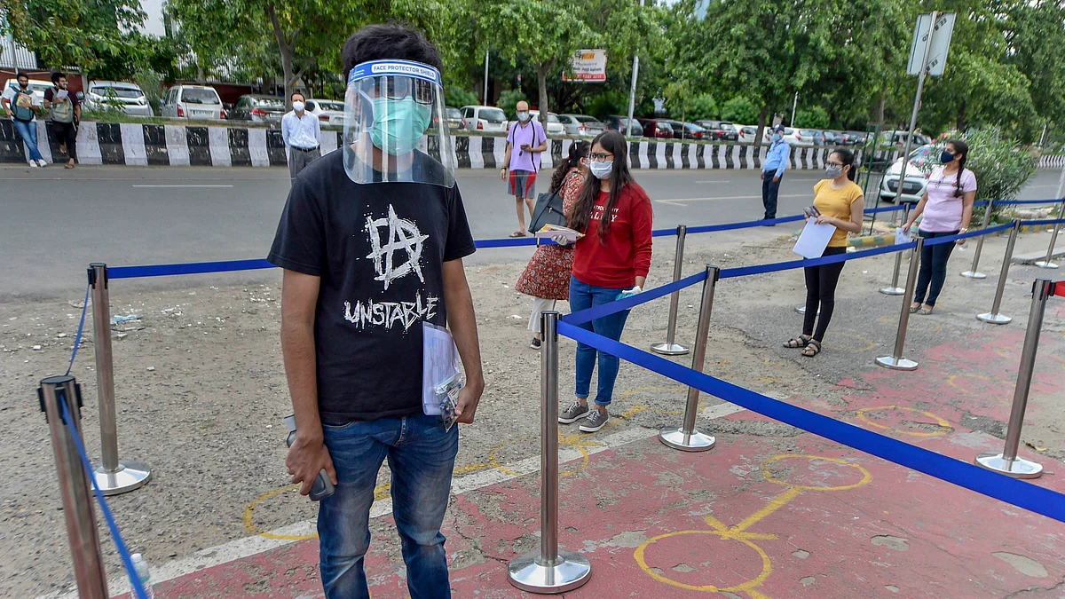 Students wait in queue, maintain social distancing outside exam centers. Image used for representation.