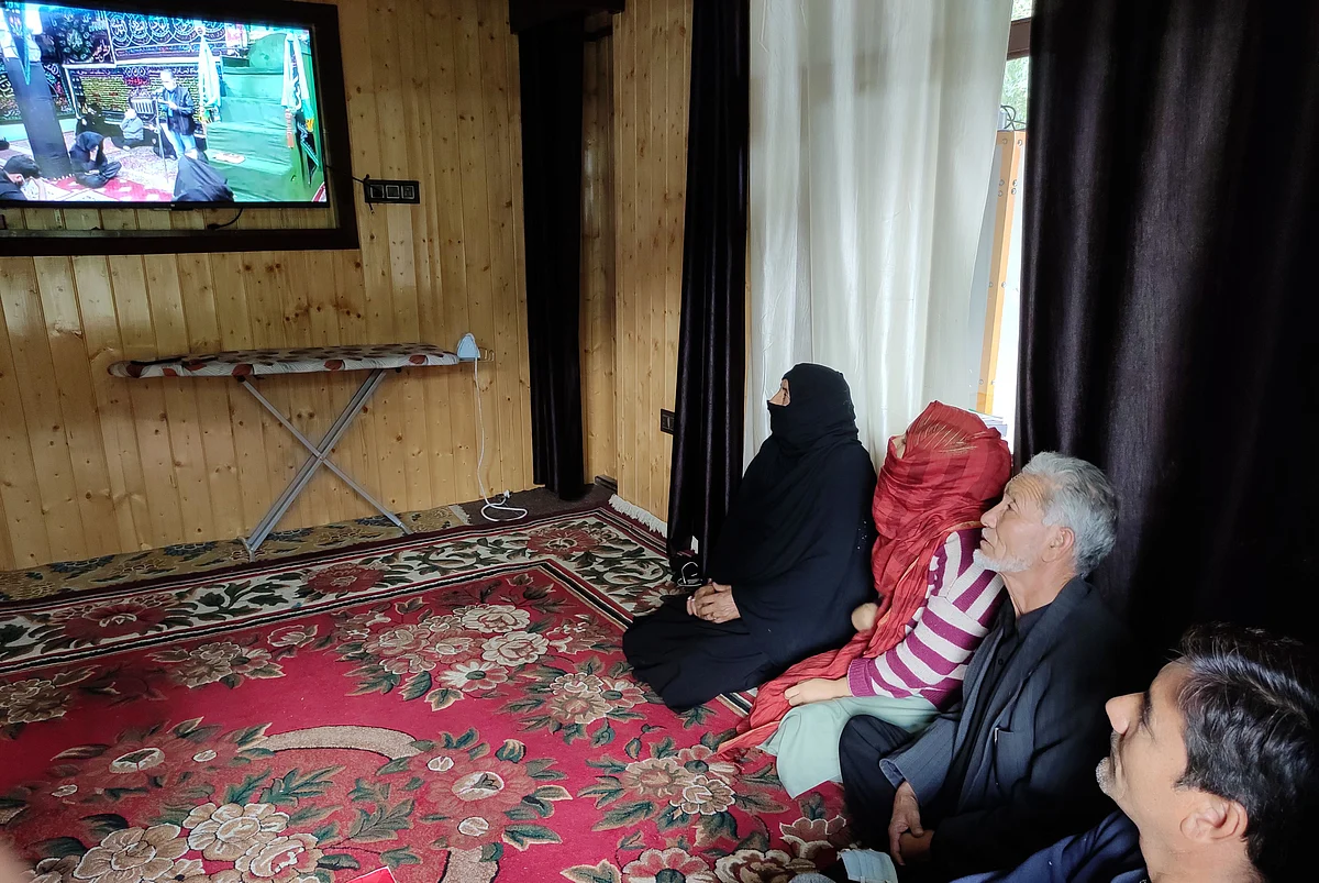 People watching live majlis on local broadcasting channel.