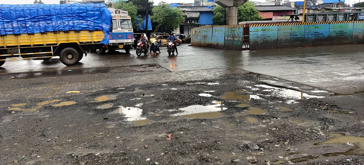 Traffic at the Baiganwadi junction where many potholes can be seen.