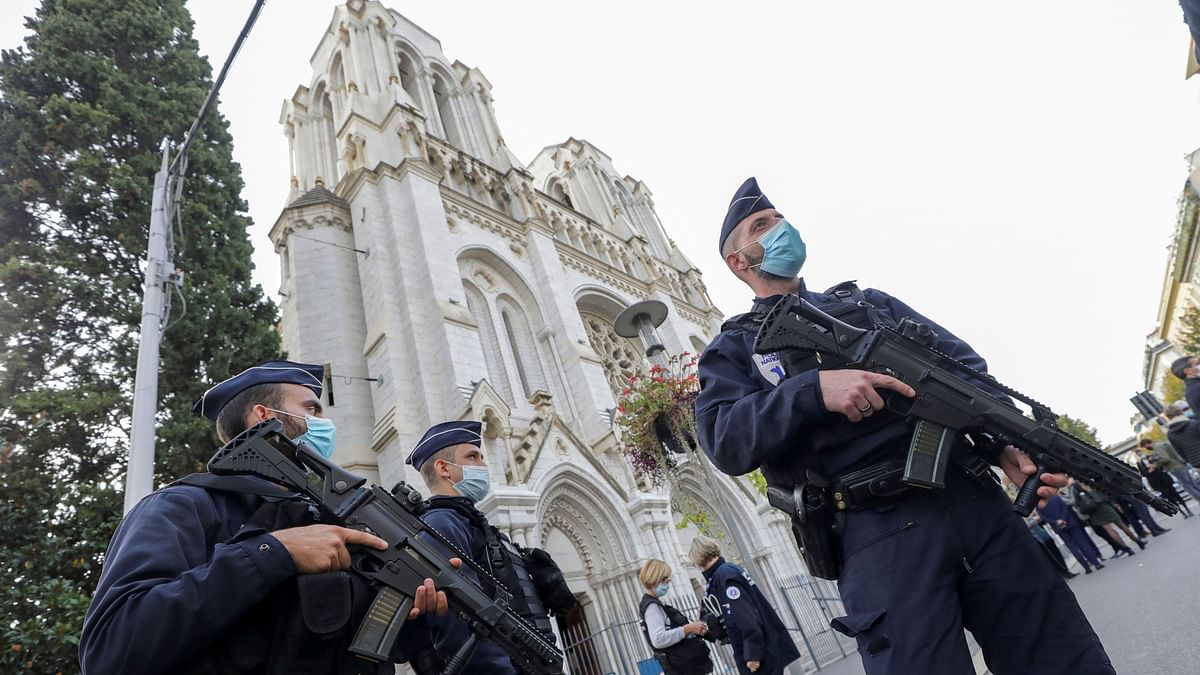 French police officers stand near Notre Dame church in Nice, southern France, Thursday, Oct. 29, 2020.