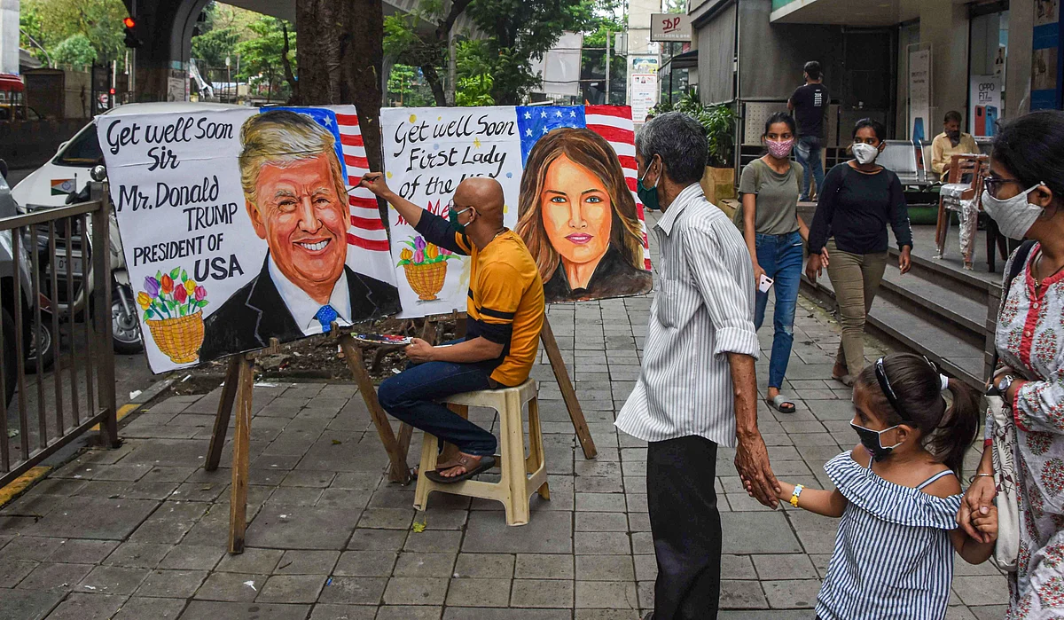 Gurukul teacher makes a painting of US President Donald Trump and US First Lady Melania Trump after they tested positive for COVID-19, at Lalbaug in Mumbai, Friday, 2 October. 