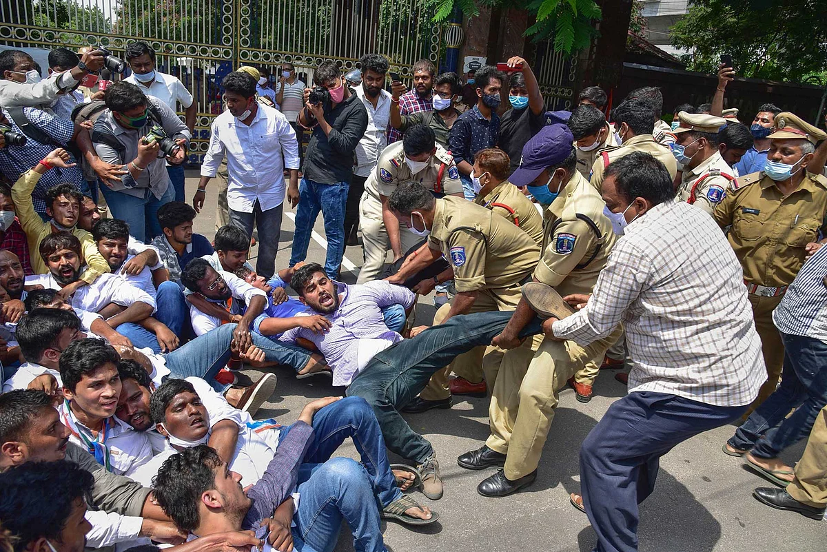 Police detain students during a protest demanding postponement of exams, at Jawaharlal Nehru Technological University in Hyderabad.