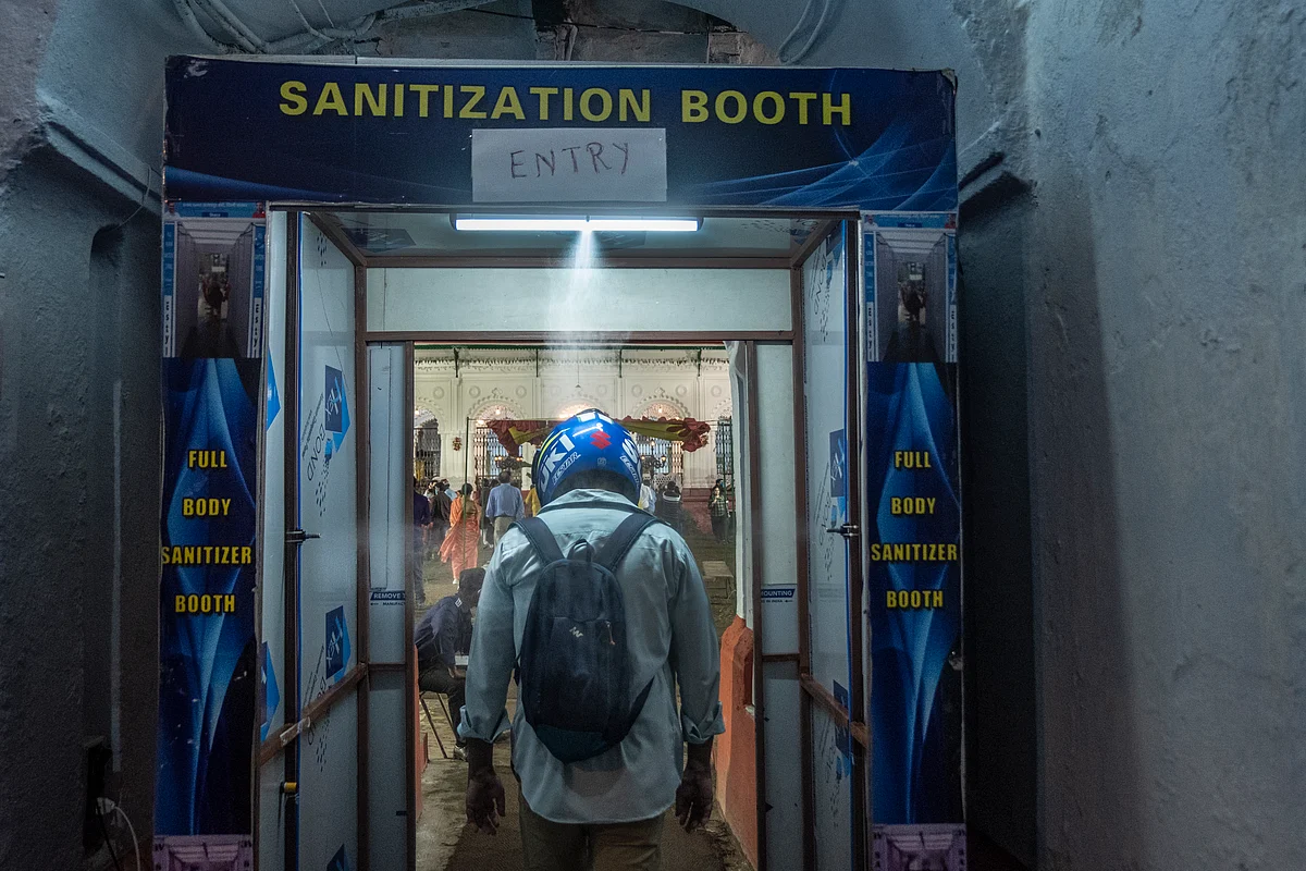 A man goes through a sanitization tunnel at Sobhabajar, Rajbhari.