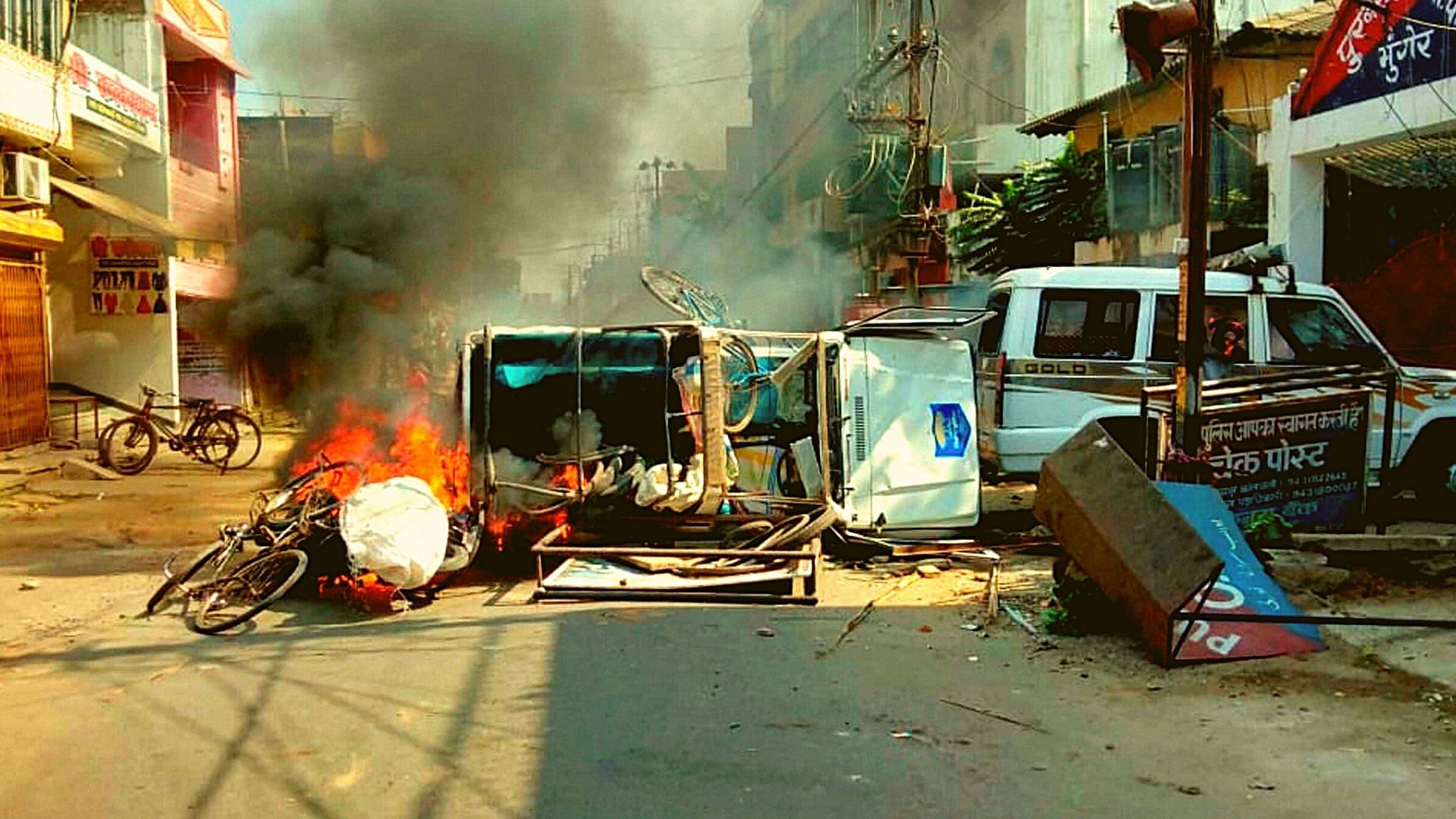 A vehicle in flames after it was set on fire by an angry mob during a protest over recent police firing during a Durga Puja event, in Munger, Thursday, 29 October.