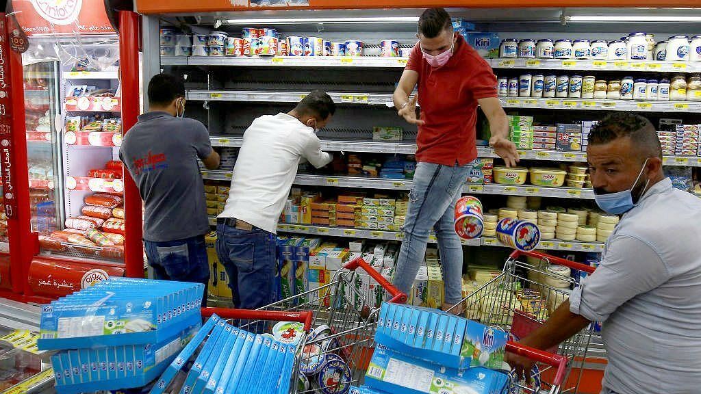 Workers at a supermarket in the Jordanian capital of Amman remove French products off the shelves during a boycott of the country’s products. 