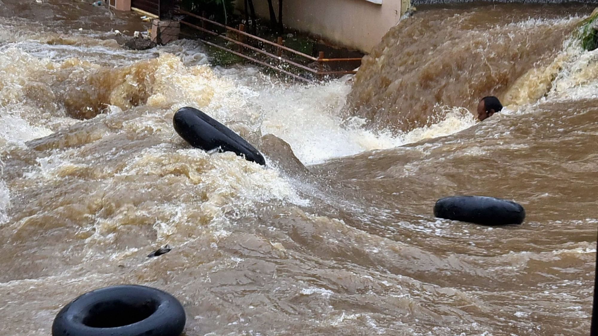 A man swept away by floodwater in Hyderabad on Tuesday, 13 October,&nbsp;