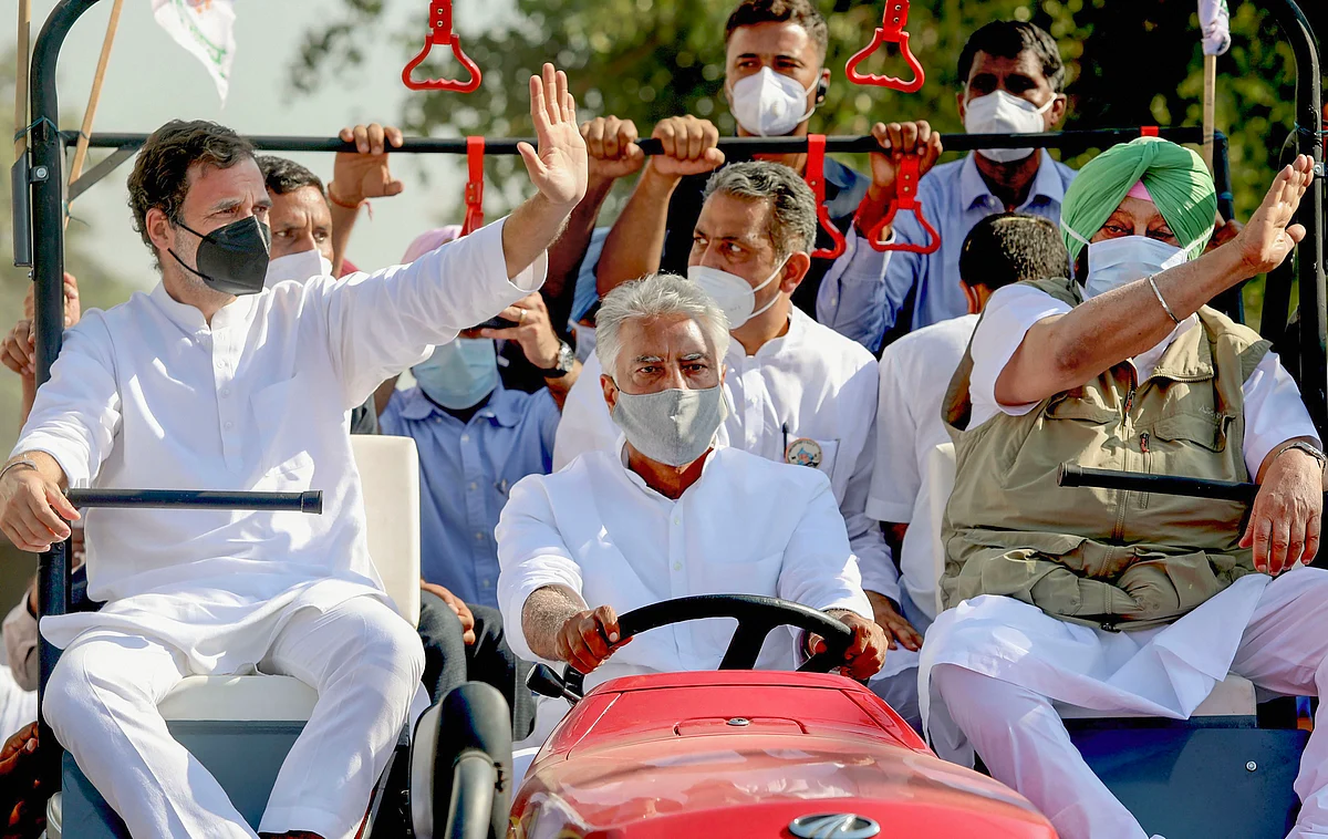 Former Congress President Rahul Gandhi and Punjab Chief Minister Capt. Amarinder Singh ride a tractor driven by PPCC President Sunil Kumar Jakhar during their Kheti Bachao Yatra over new farm laws, in Sangrur district.