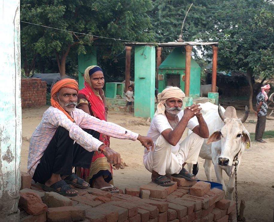 The Thakurs sitting in front of the temple where the Dalits are not allowed entry.