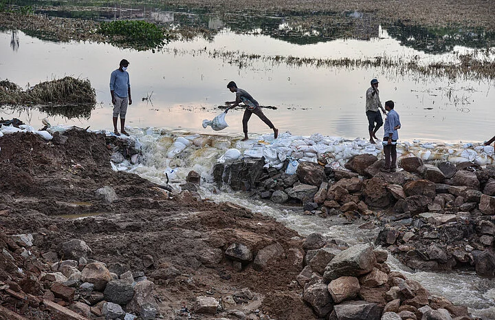 Irrigation department officials reinstate the breached embankment of the Balapur Talab, anticipating heavy rains as predicted by the IMD, in Hyderabad, Monday, Oct 19, 2020.