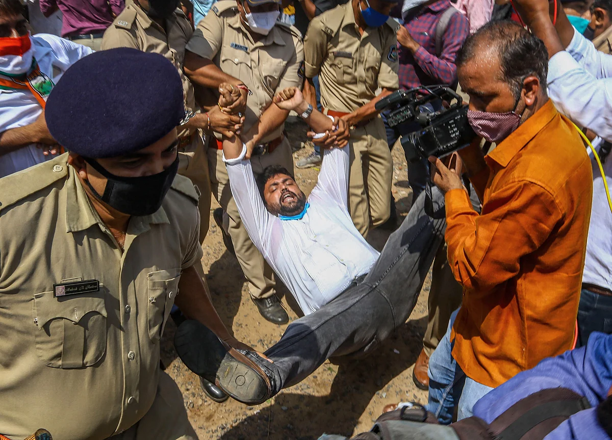 Police detain supporters of the Congress Party during their protest against farm law, outside the collector office in Ahmedabad, Friday, 2 October. 