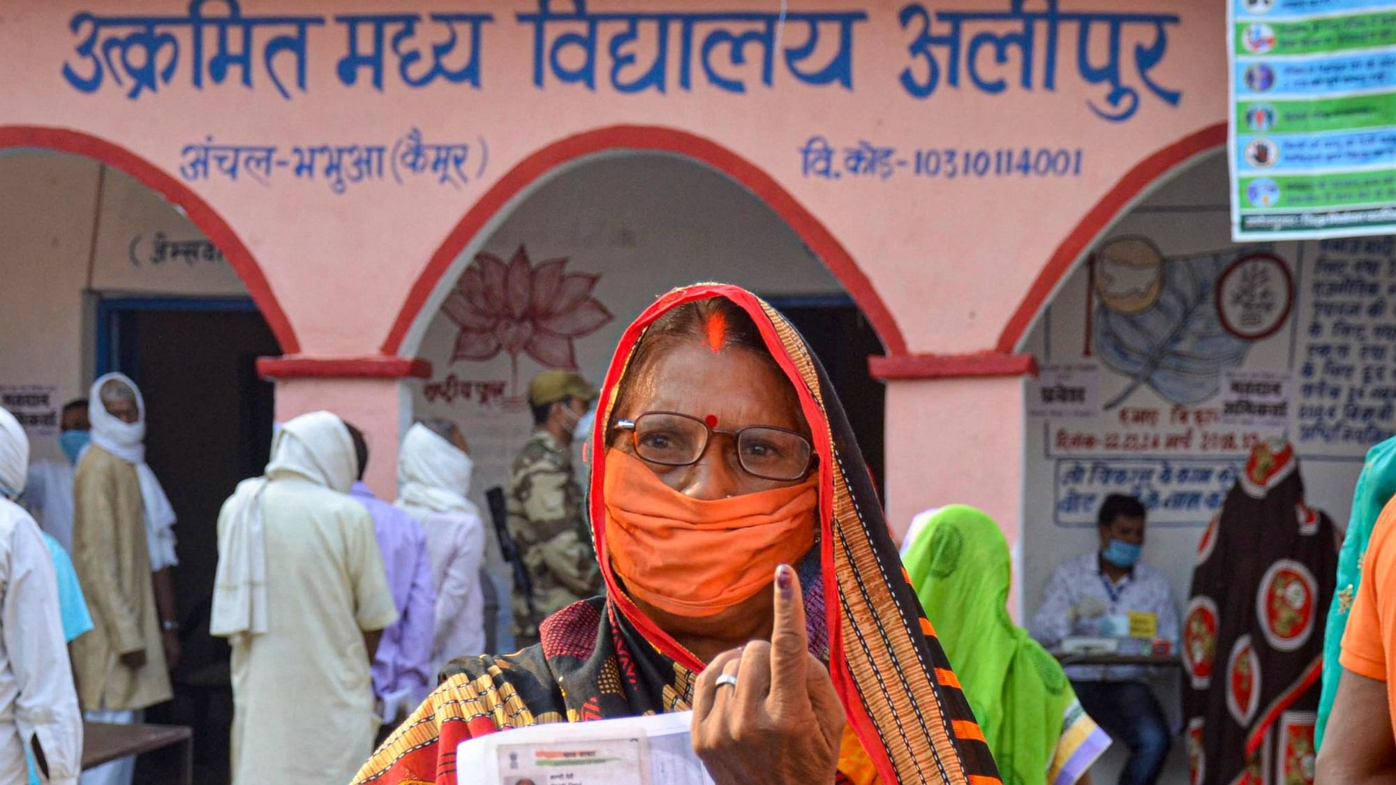 A voter shows her finger marked with indelible ink after casting her vote for the first phase of Bihar Assembly Election, amid the coronavirus pandemic, at Bhabua police station in Kaimur district, Wednesday, 28 October.