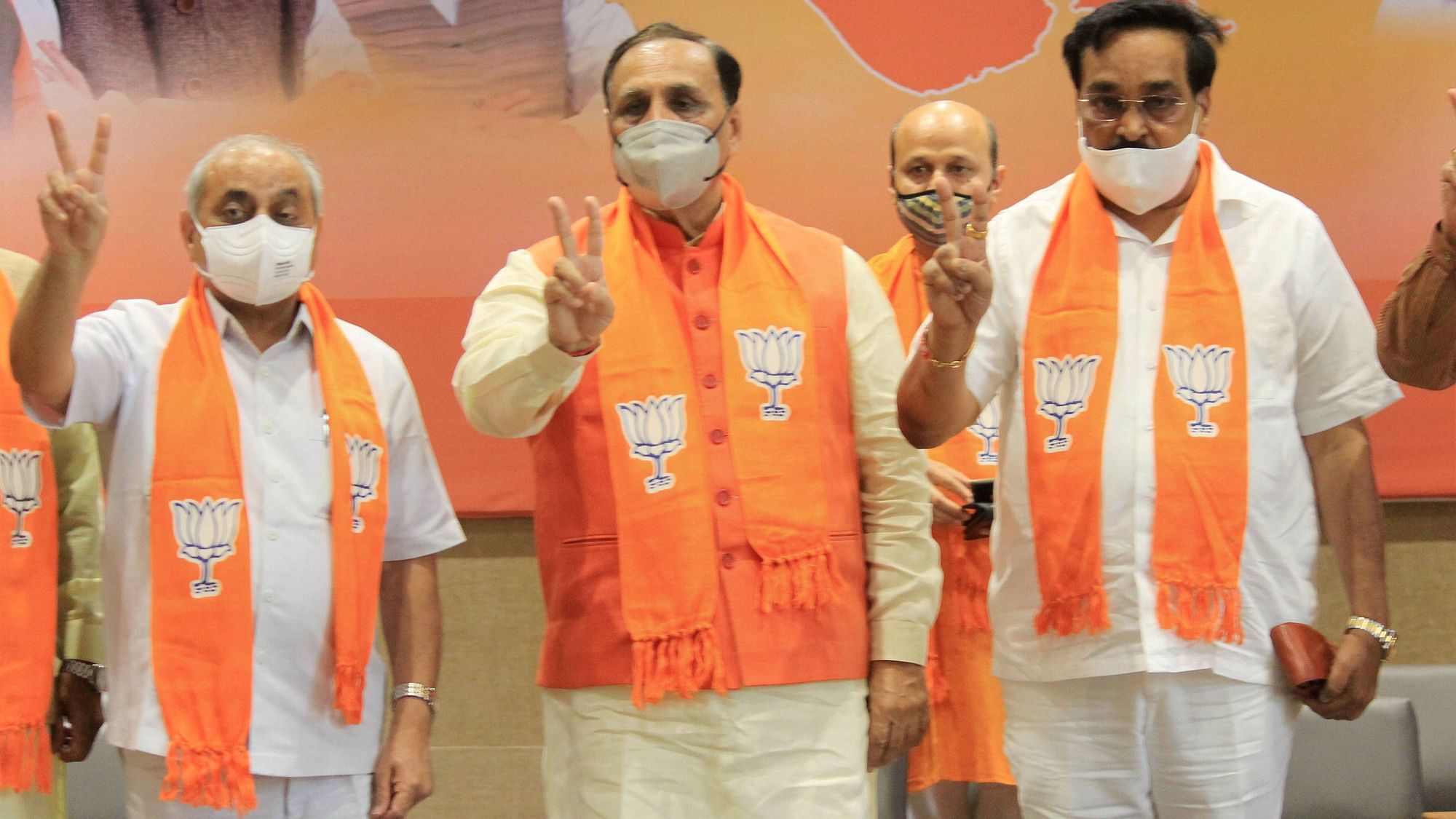 Gujarat CM Vijay Rupani, Deputy CM Nitin Patel, and BJP State President CR Patil flash the victory sign during counting of votes for Madhya Pradesh bypolls and Bihar Assembly polls, in Gandhinagar