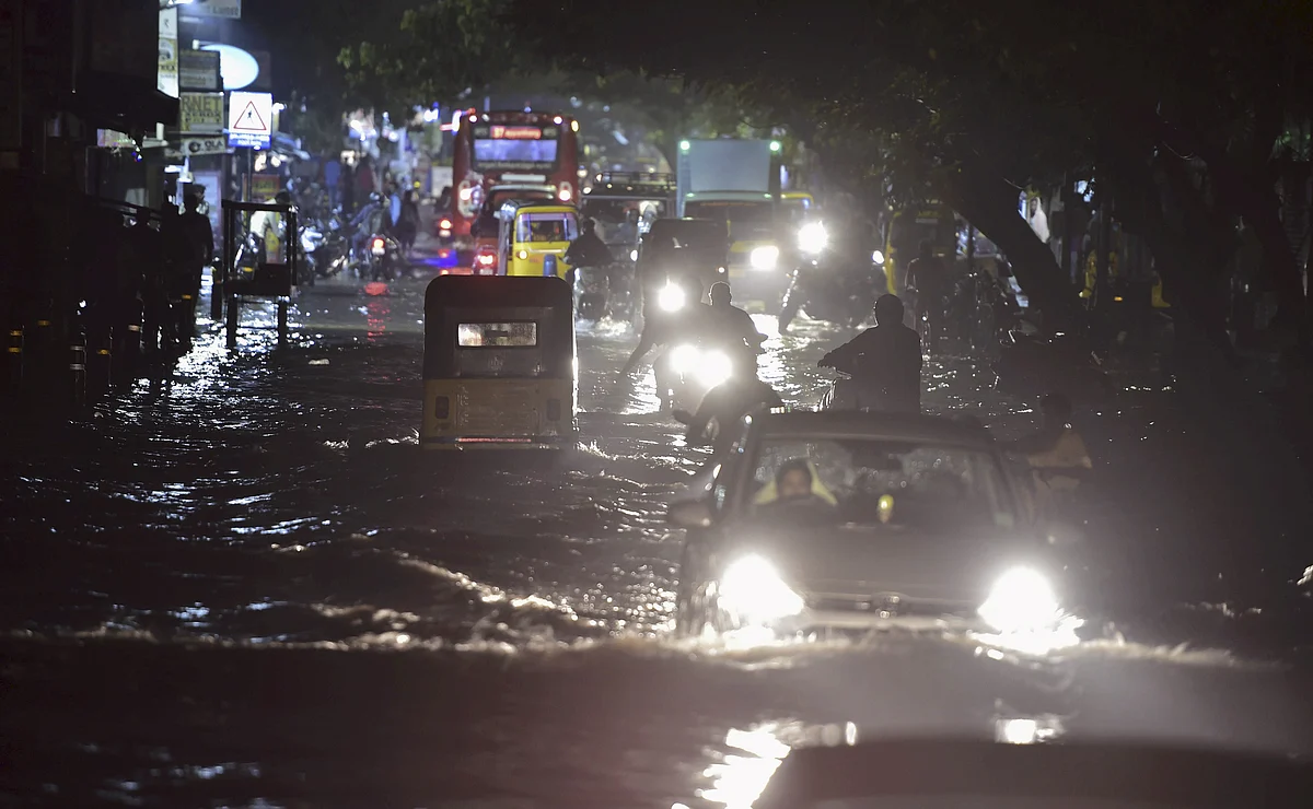 Vehicles ply on a waterlogged road during heavy rain triggered by Cyclone Nivar, in Chennai, Tuesday, November 24.