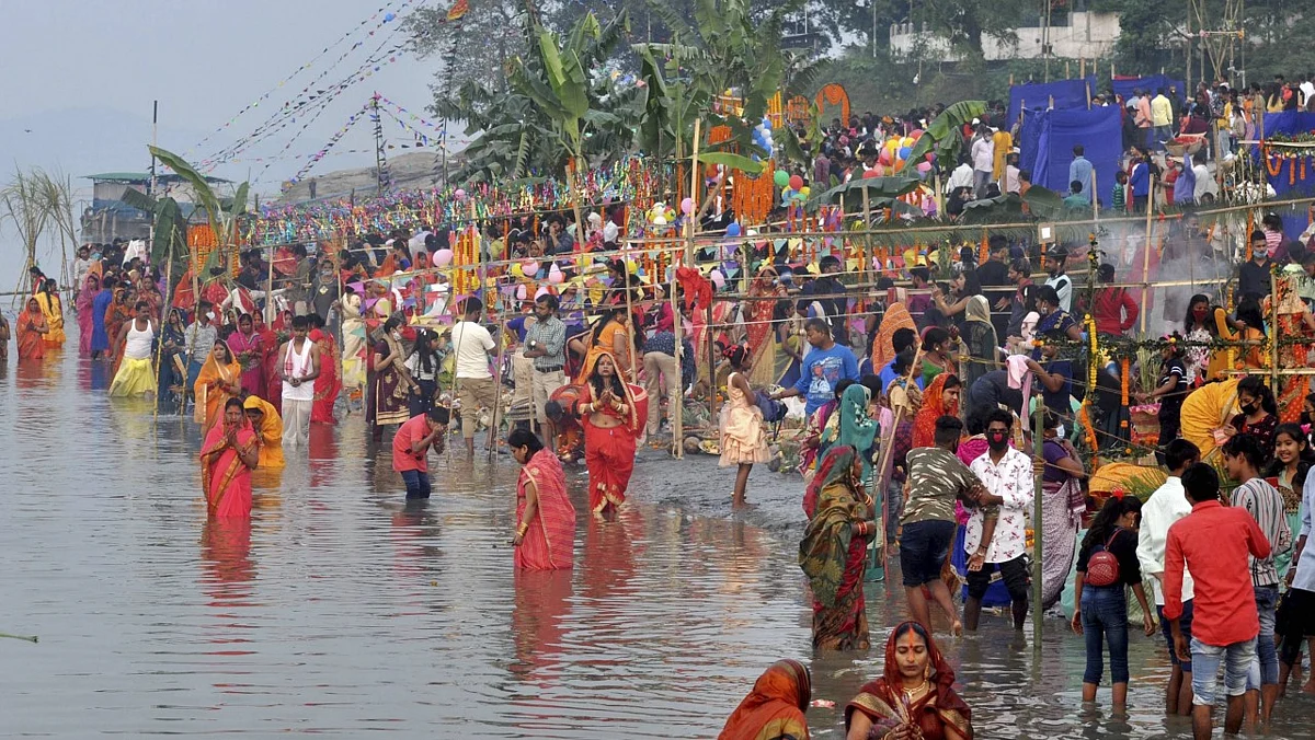 Devotees perform rituals during Chhat Puja at the bank of River Brahmaputra in Guwahati.