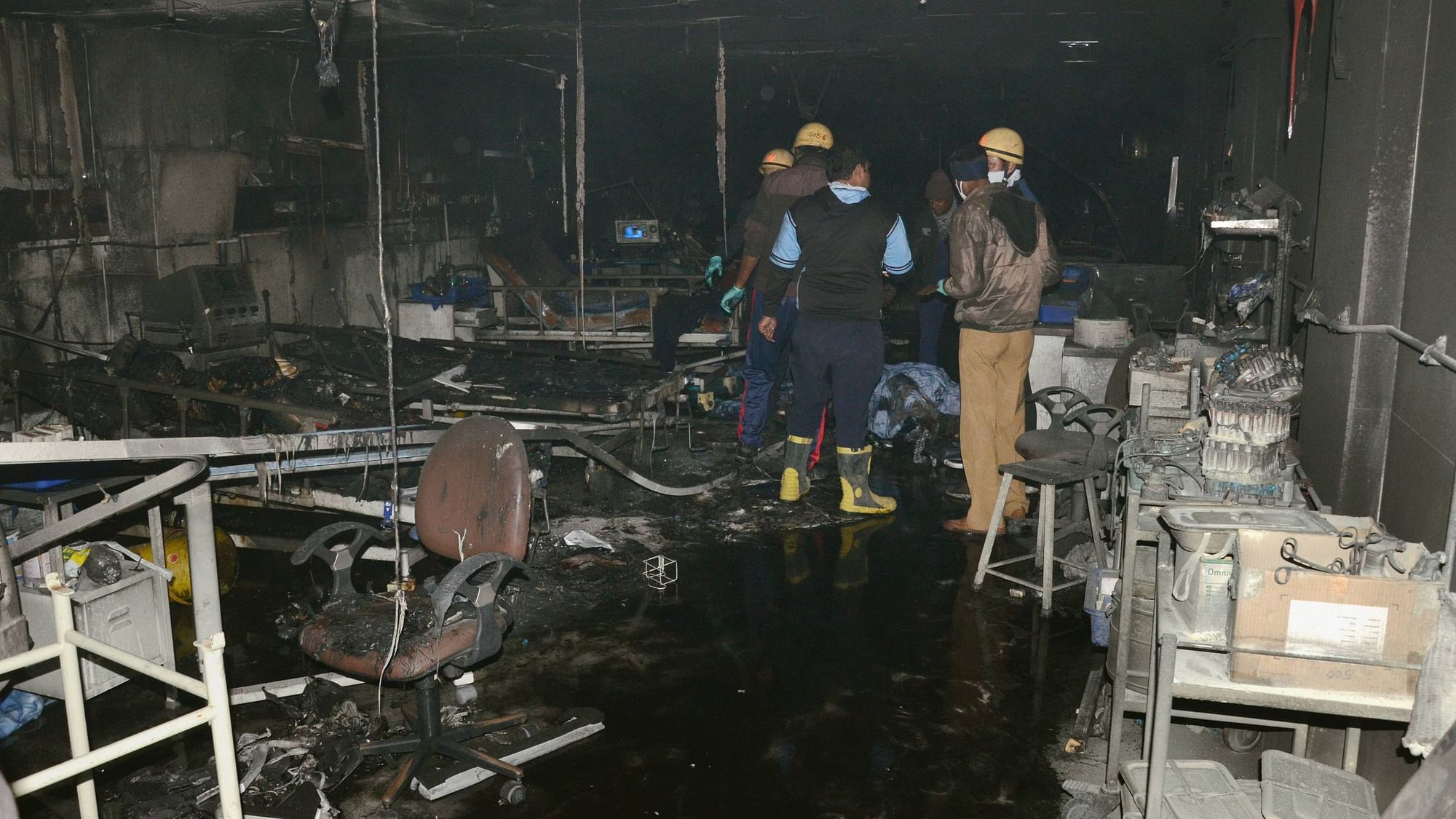 Firefighters inside the ICU of a COVID-19-designated hospital where the fire broke out  in Rajkot, on Friday, November 27.