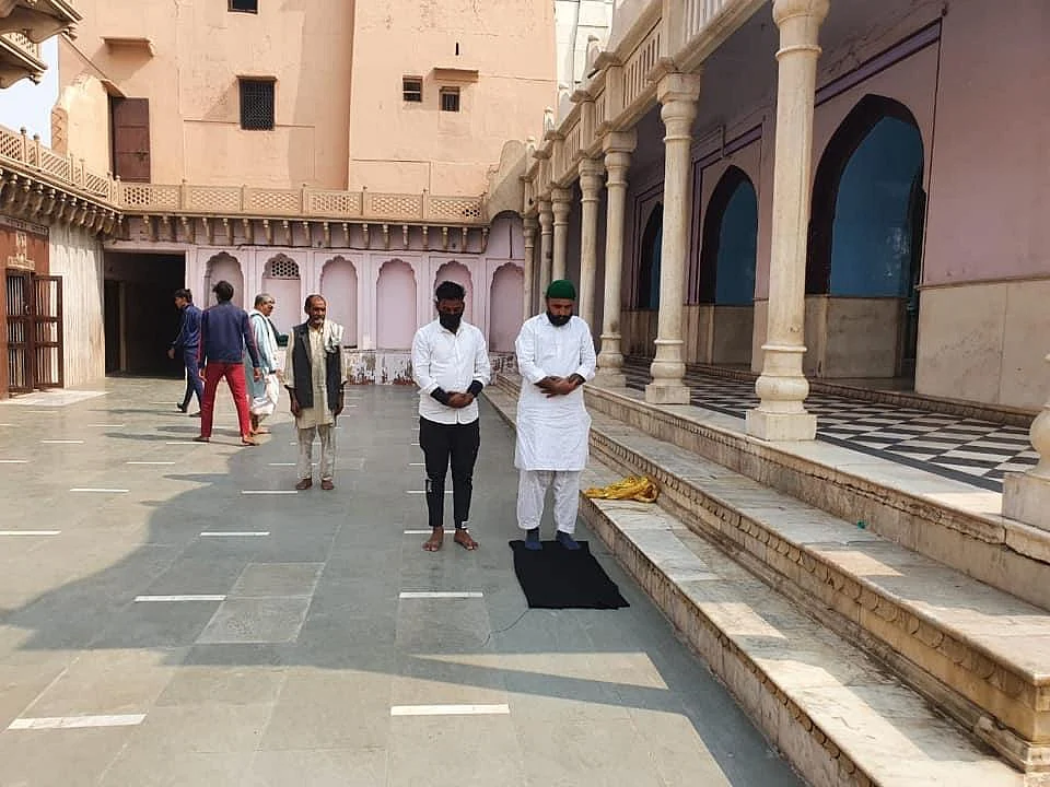 In this image, one can see the priest from the previous picture, who is wearing the glasses, in the background.