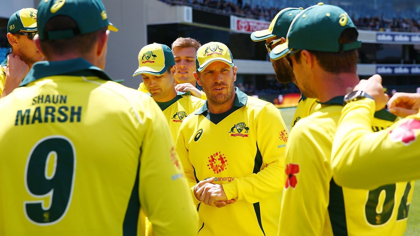 Australian captain Aaron Finch speaks to his team in a huddle.