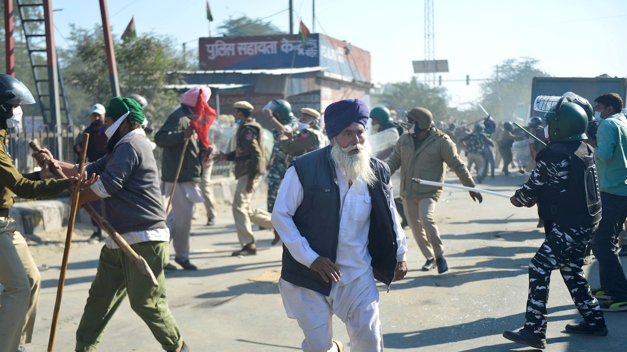 Security personnel and farmers clash as protestors attempt to cross Singhu Border during Delhi Chalo march against the new farm laws in New Delhi, Friday, 27 November 2020.