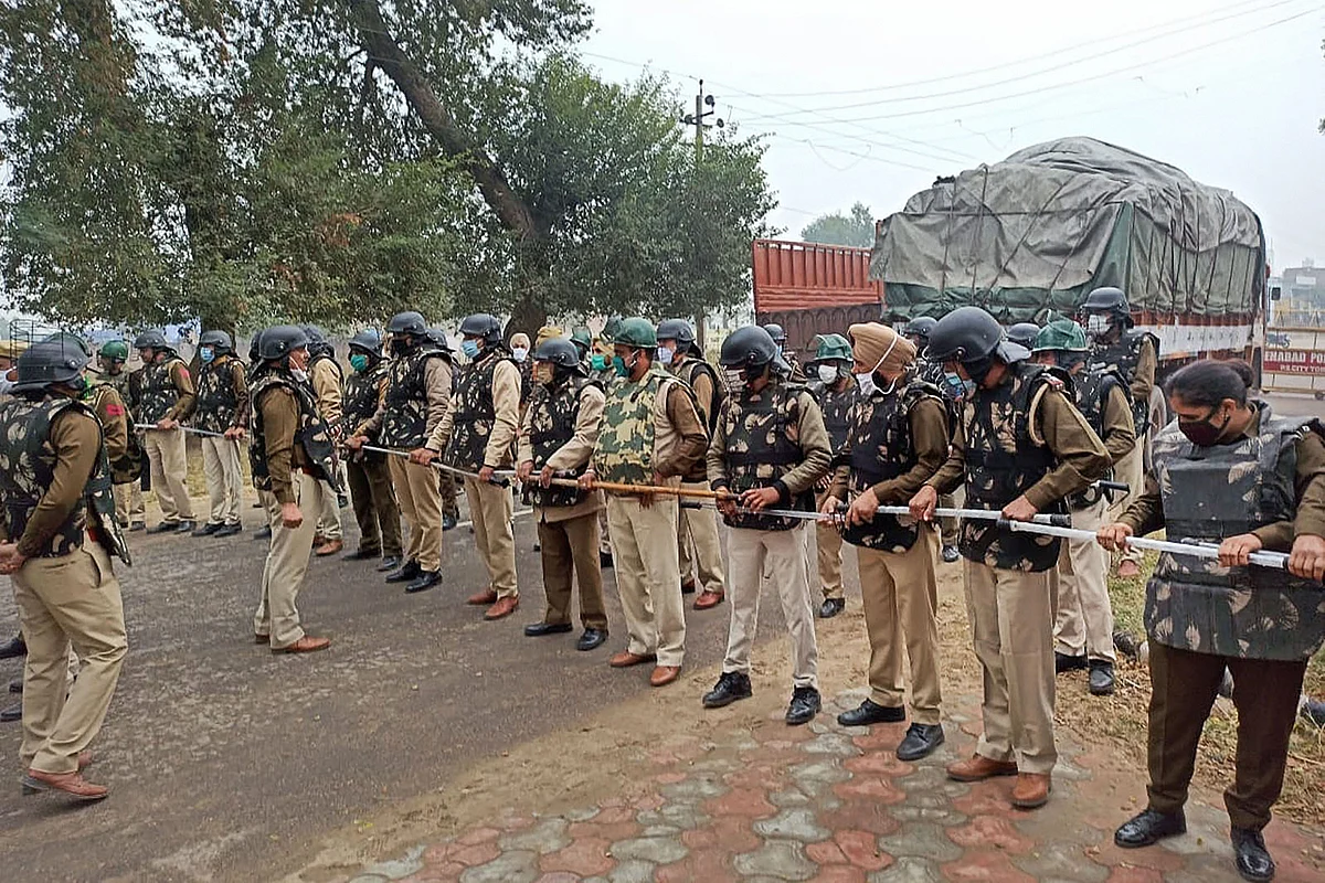Police make a human barricade to stop various farmer organisations during a protest march against the farm reform bills, in Hisar district, Wednesday, 25 November, 2020. 