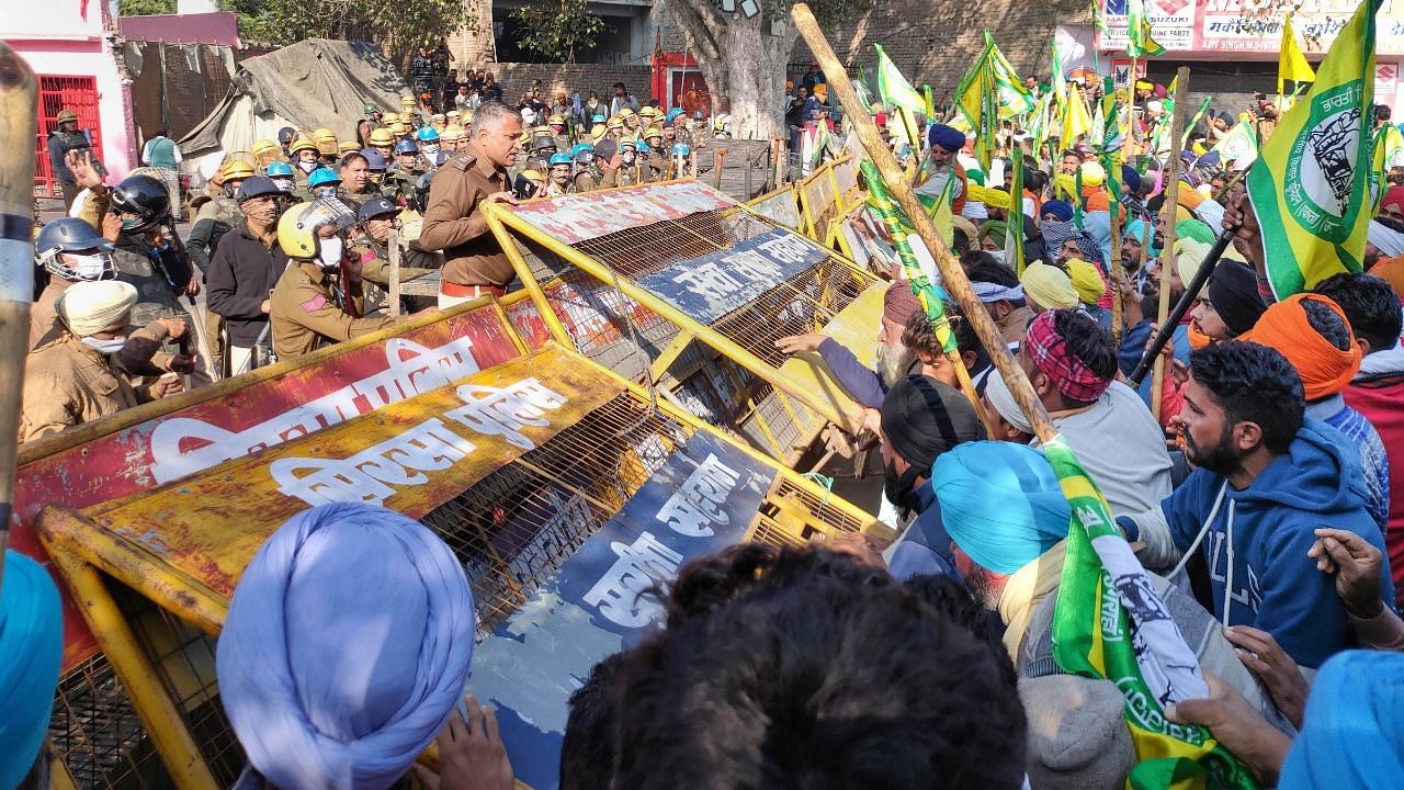 Farmers try to cross police barricade at Dabwali border of Punjab and Haryana during their Delhi Chalo protest.