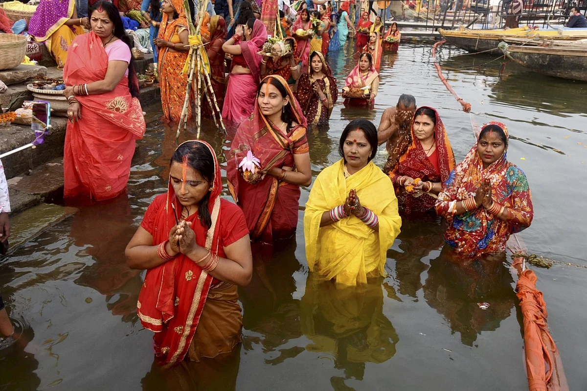 Devotees pray to the Sun God on the occasion of Chhath Puja at a Ganga ghat in Varanasi.