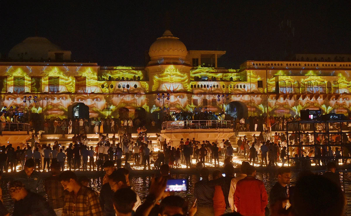 Devotees light earthen lamps on the bank of Saryu River during Deepotsav celebrations in Ayodhya, Friday, 13 November.