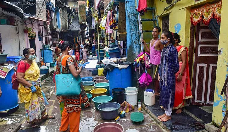 Health care workers conduct door-to-door survey in Dharavi