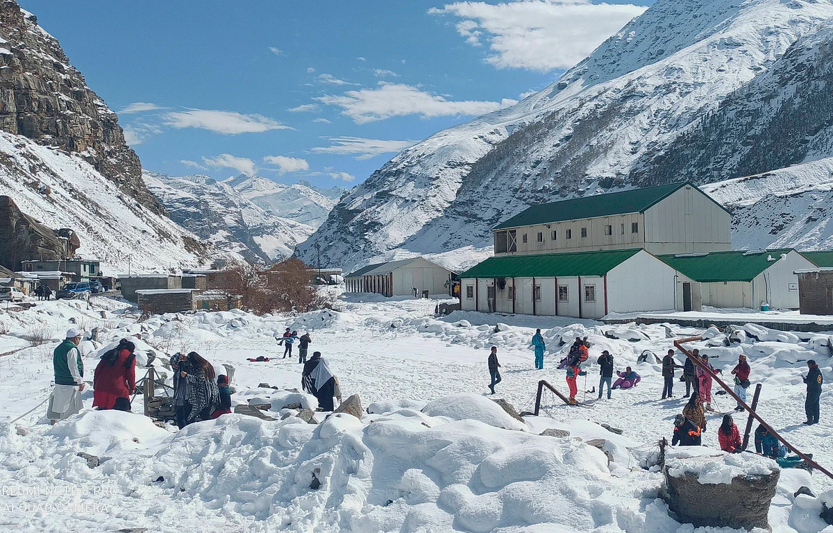 Tourists play in the snow near the Atal Tunnel, in Lahaul-Spiti.