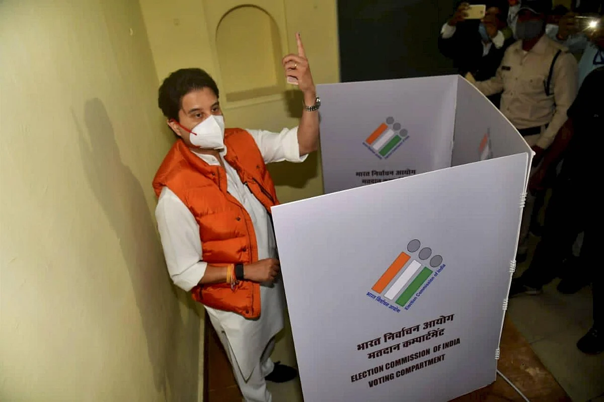 BJP leader Jyotiraditya Scindia raises his finger before casting vote during the Madhya Pradesh Assembly bypolls, amid the ongoing coronavirus pandemic, in Gwalior district, Tuesday, 3 November.