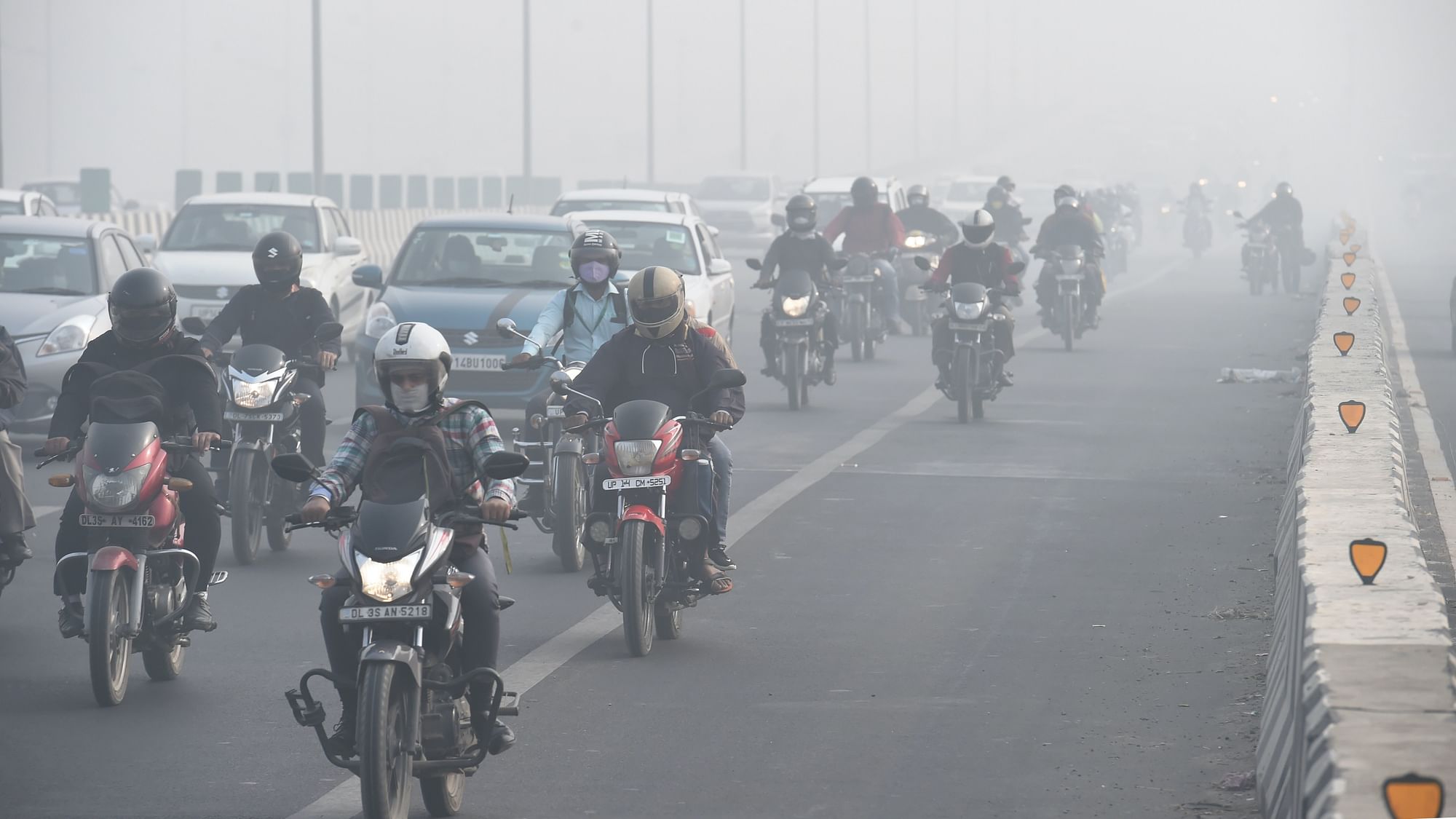 Vehicles ply amid low visibility due to smog in New Delhi onTuesday, 10 November.