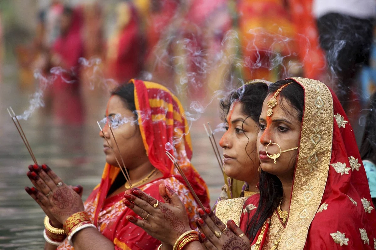 Devotees pray to the Sun God in a pond on the occasion of Chhath Puja in Agartala.