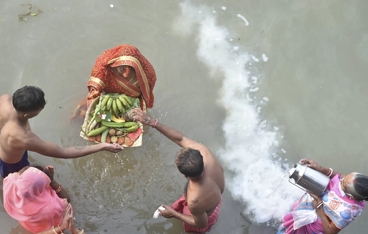 Devotees perform rituals at the bank of River Ganga, on the occasion of Chhath Puja in Kolkata.