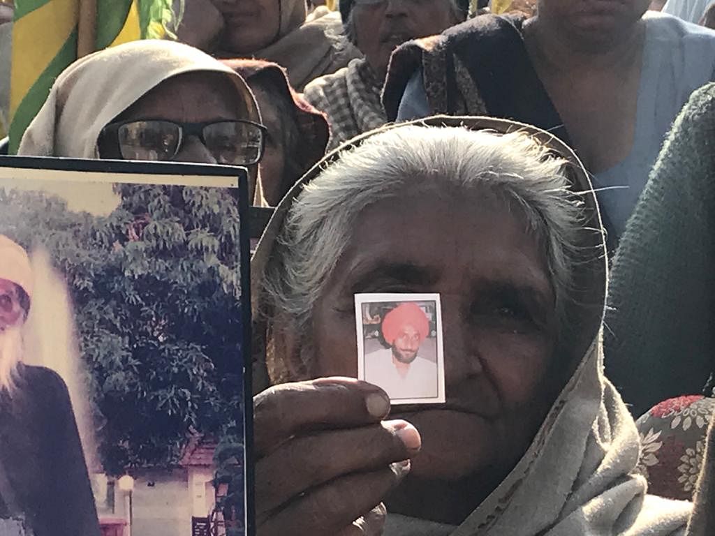 Holding photographs of their kin, the women raised slogans against the new farm laws, at Delhi’s Tikri border.