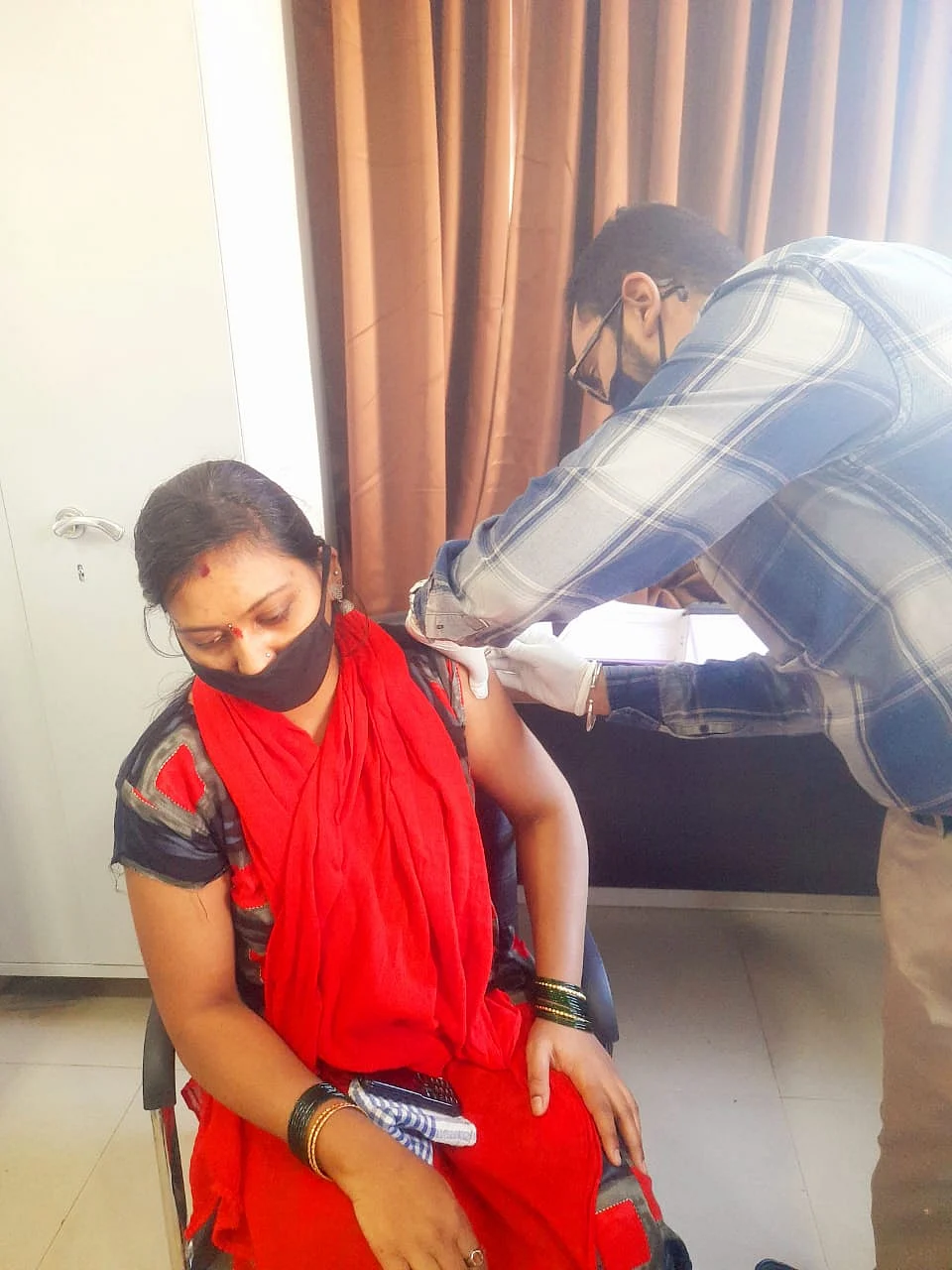 Rajeshwari receiving the first shot of Bharat Biotech COVID-19 vaccine.
