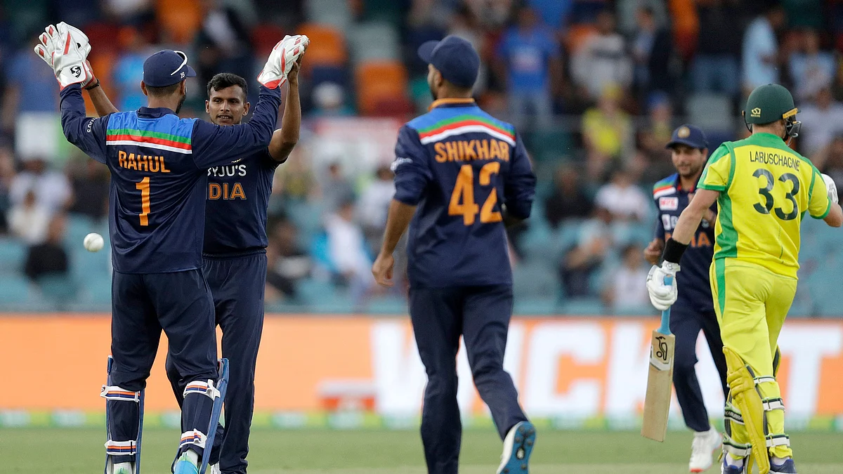 T Natarajan, second left, is congratulated by teammate India’s K.L. Rahul after bowling Australia’s Marnus Labuschagne, right, for 7 runs during the ODI on 2 December, 2020.