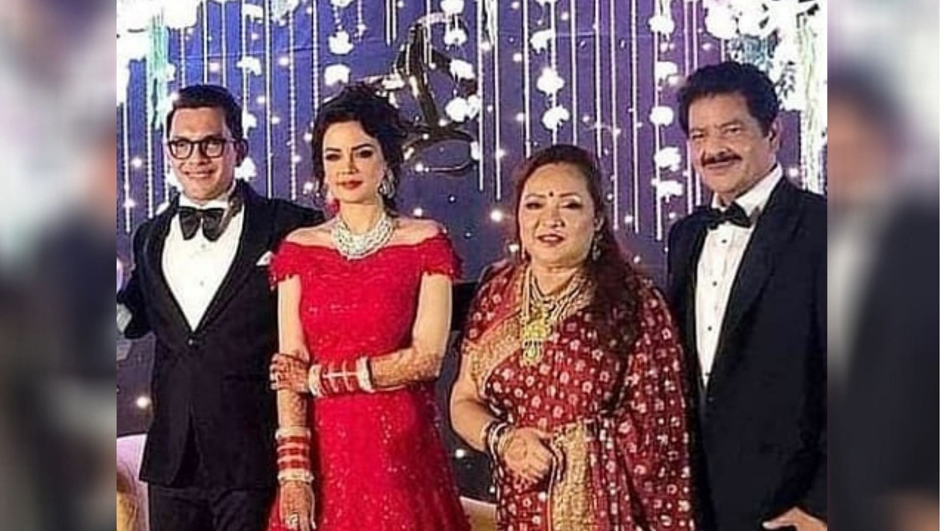 Newly weds Aditya and Shweta pose for photos with Udit Narayan and his wife.