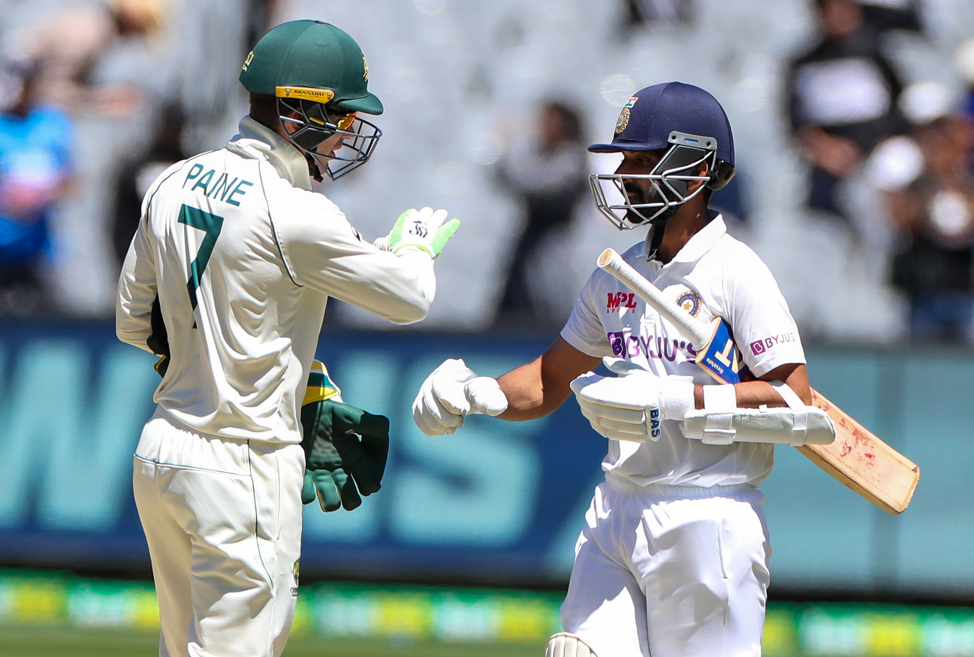 Australian captain Tim Paine, left, congratulates Indian captain Ajinkya Rahane after winning the second test at the Melbourne Cricket Ground.