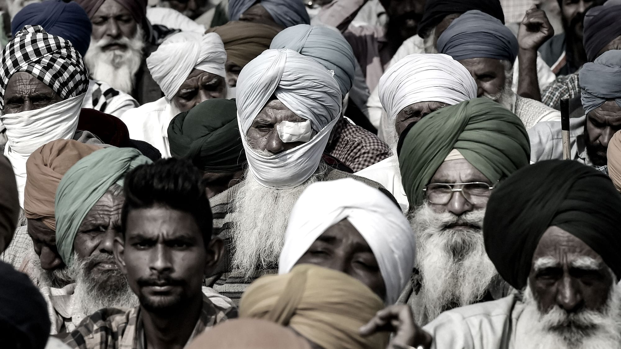  An injured farmer sits among others as they stage a protest at Singhu border against the Centres new farm laws, in New Delhi.