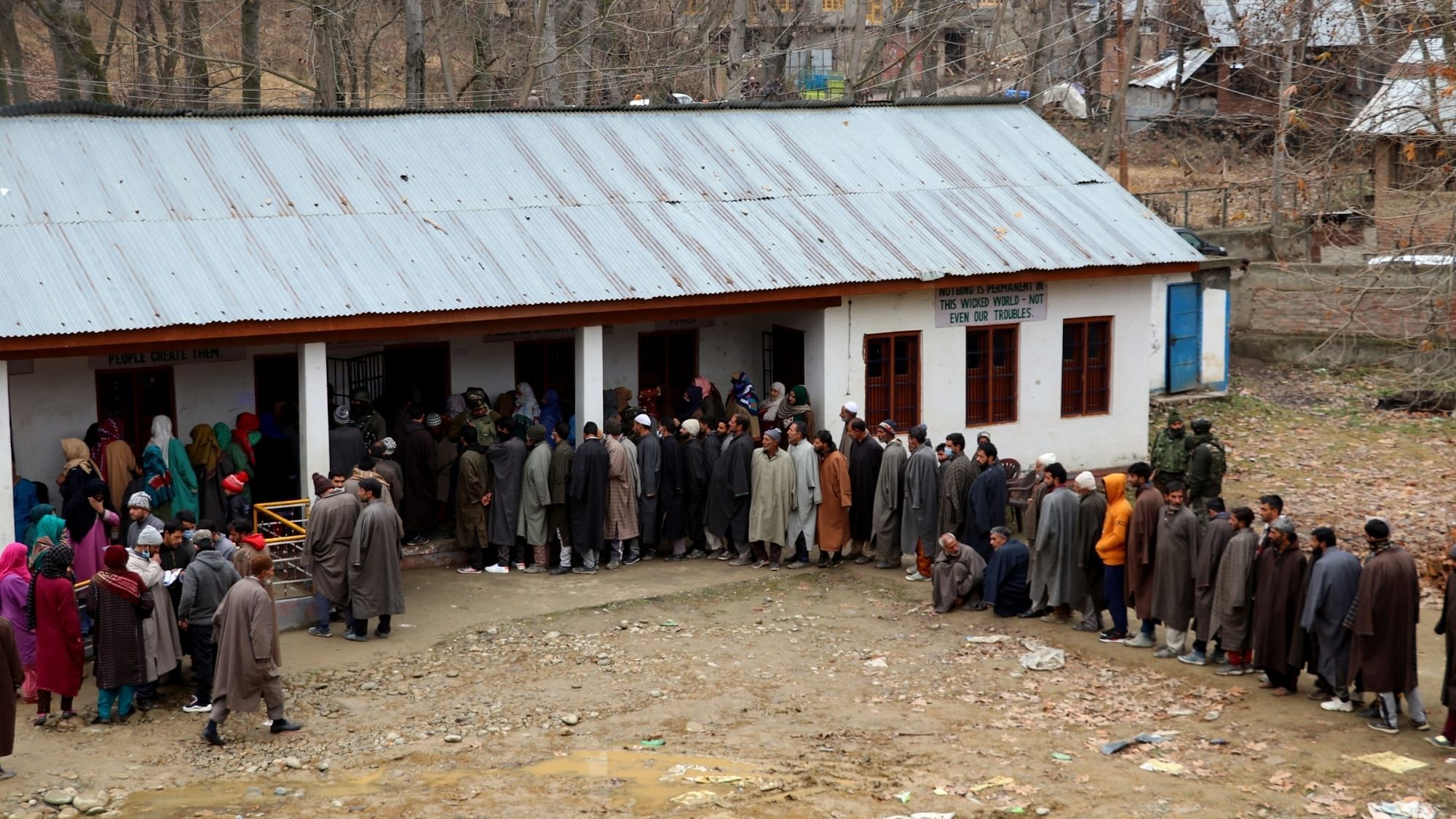 Voters queue up outside a polling station to cast their votes for the fifth phase of District Development Council (DDC) elections in Jammu and Kashmir’s Pulwama on Dec 10, 2020.
