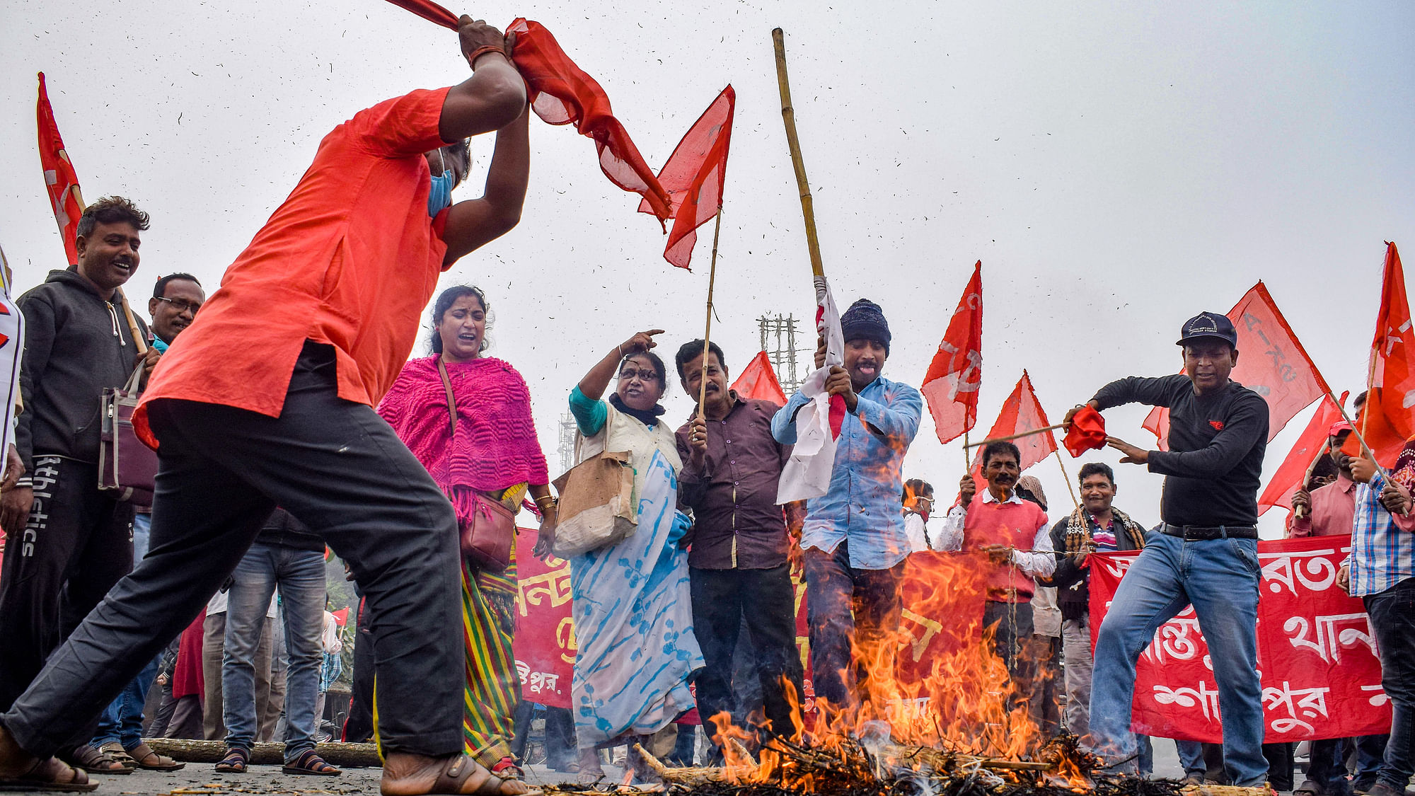 Demonstrators burn various items as they block NH-12 during a protest in support of the nationwide strike, called by farmers to press for the repeal of the Centre’s farm laws, in Nadia, West Bengal.