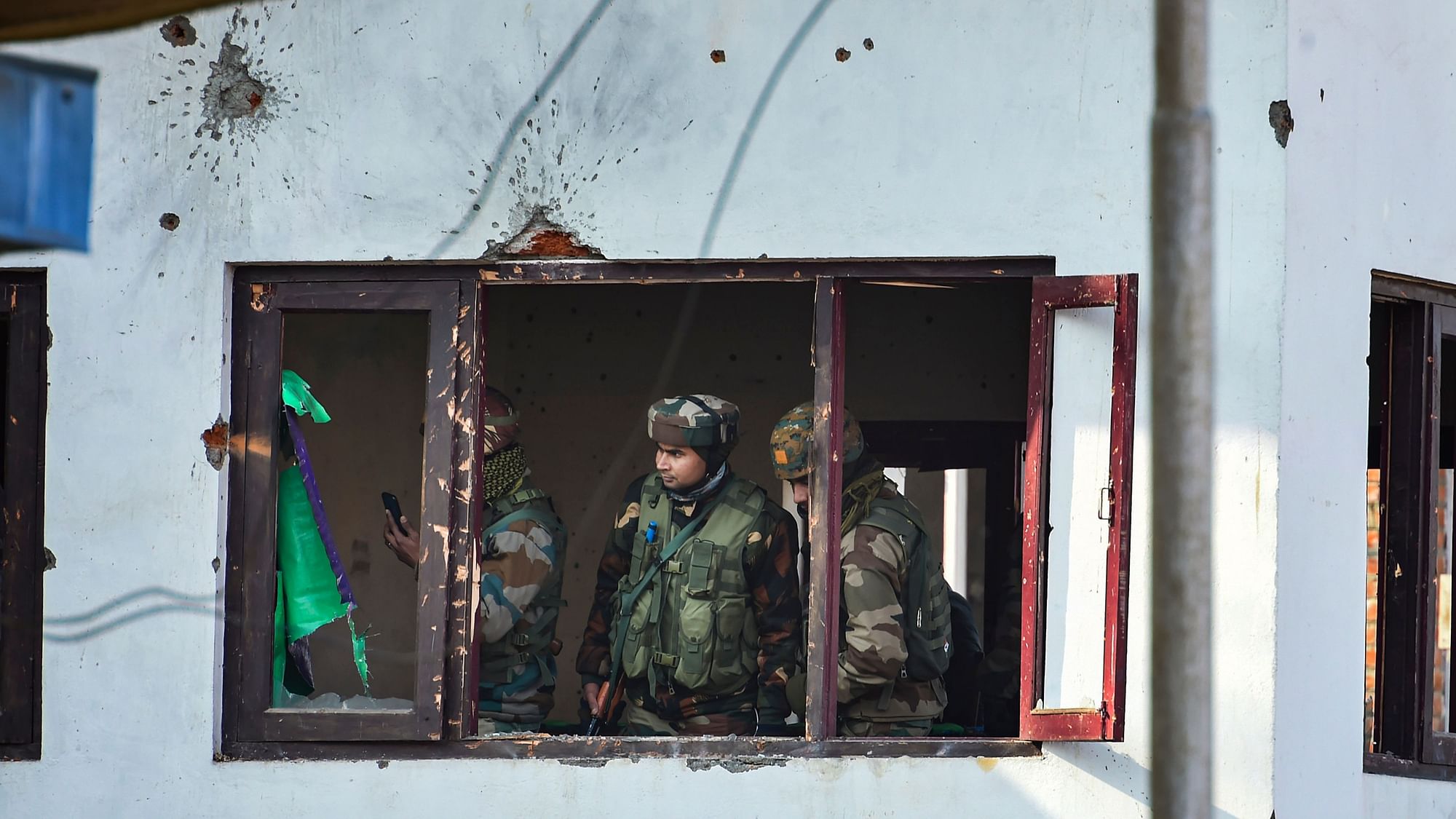 Army personnel conduct searches in the house where militants were hiding, after an encounter with them, at Lawaypora on the outskirts of Srinagar, on Wednesday, 30 December 2020. Three militants were killed in the encounter.