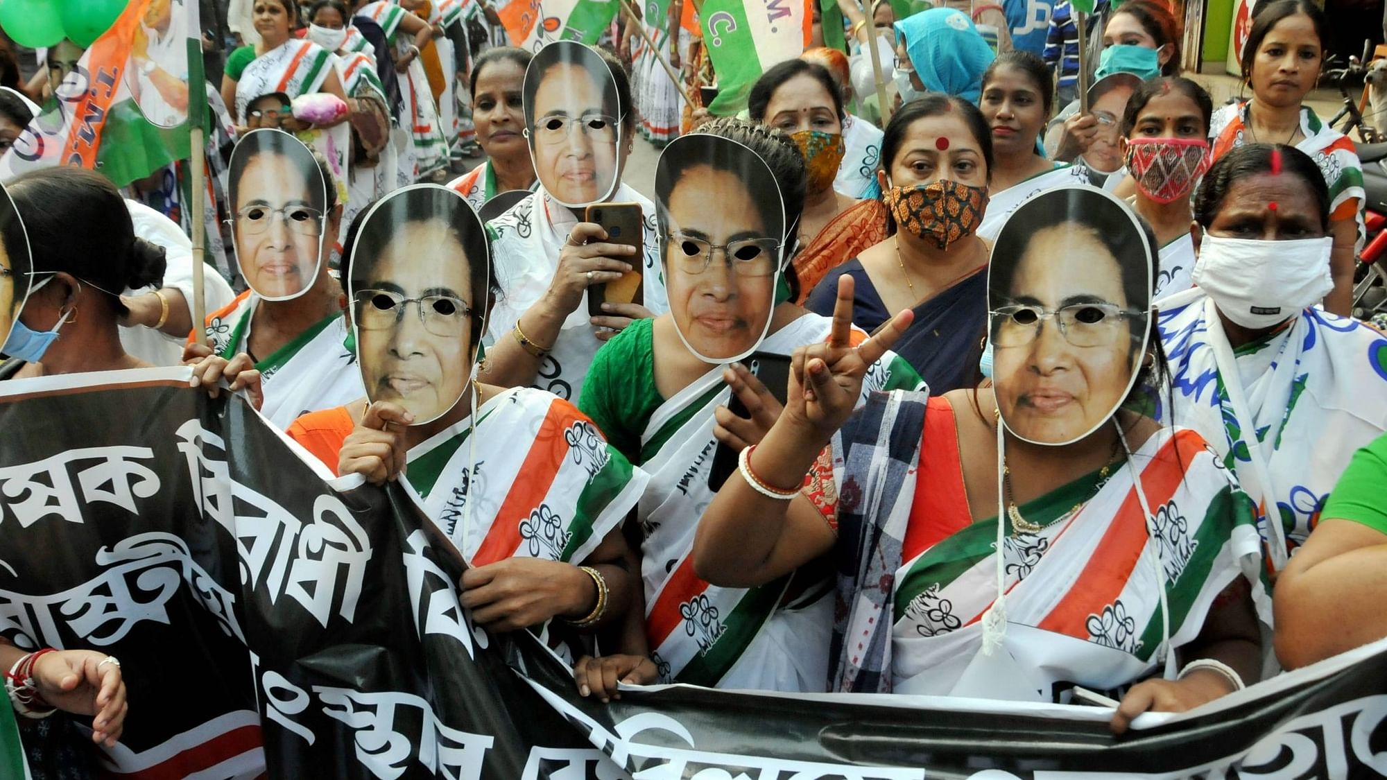 Kolkata: Trinamool Congress workers, wearing masks with West Bengal CM Mamata Banerjees photograph, participate in a promotional campaign rally Bangadhani, in Kolkata, Friday, 11 Dec, 2020.&nbsp;