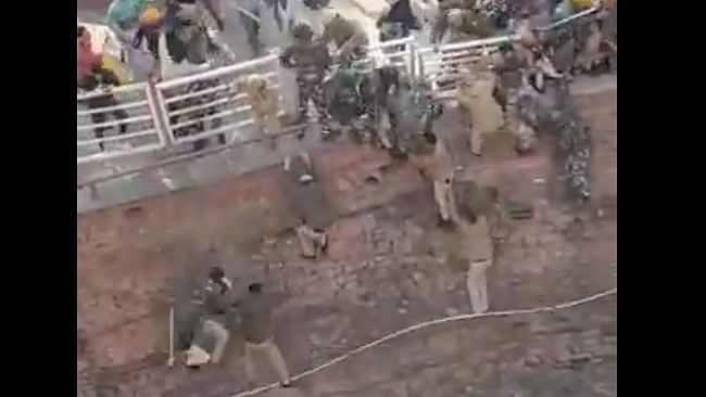 In the video, the protesters can be seen thrashing the police — many of who, in a bid to save themselves, jumped off the edge of a railing and into a grassy pit below.