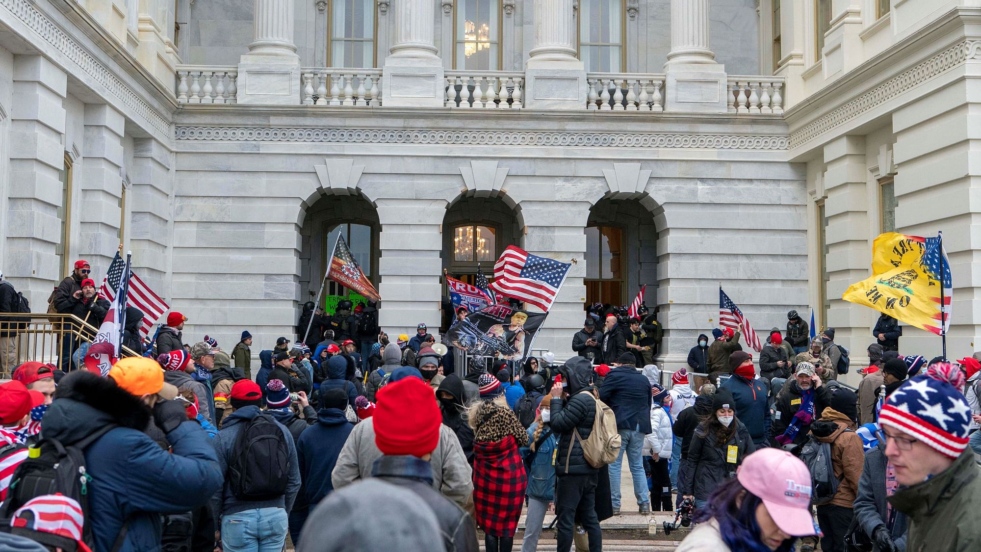 Supporters of President Donald Trump try to open a door of the U.S. Capitol on Wednesday,  6 January, 2021, in Washington.