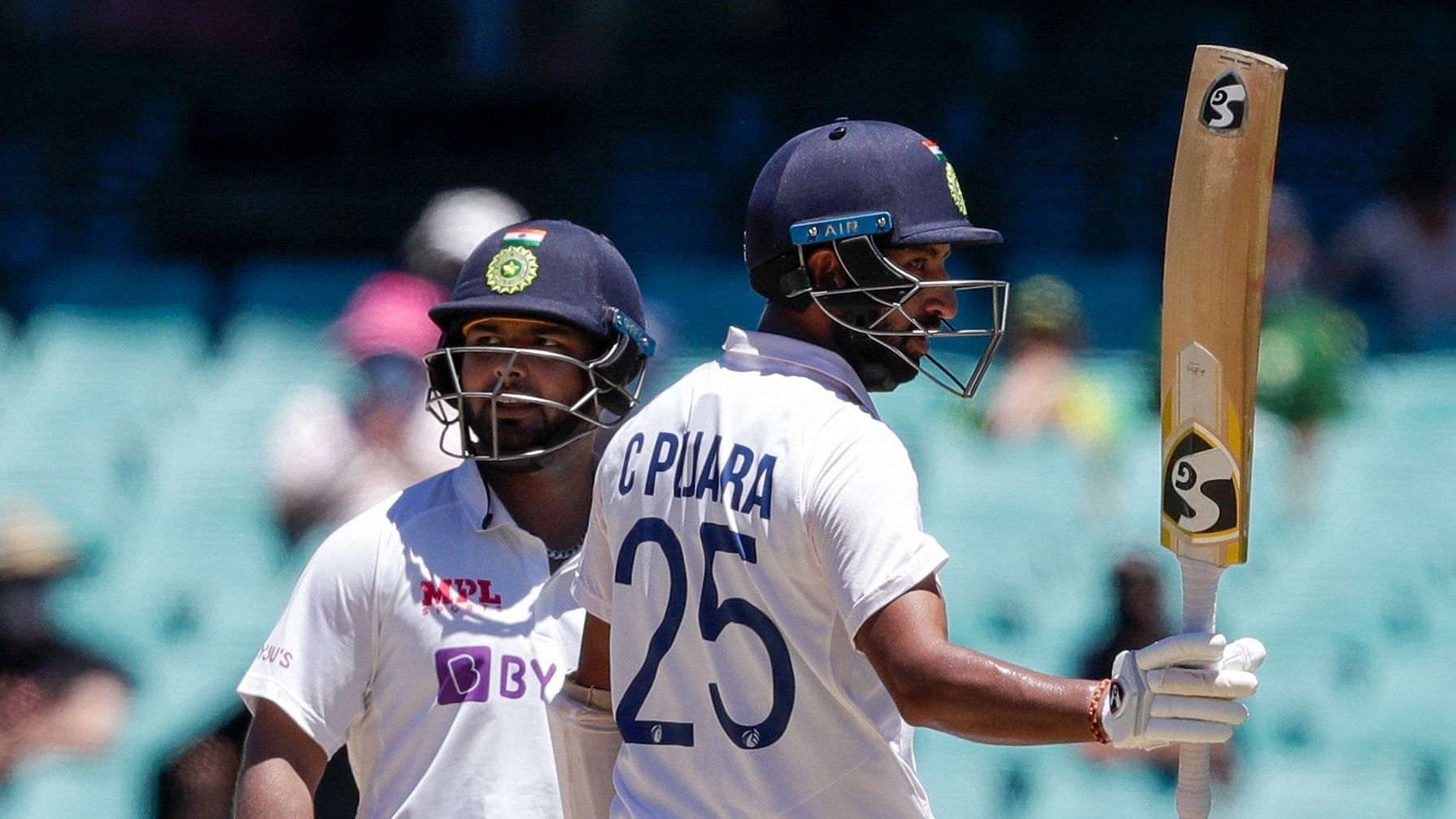 Cheteshwar Pujara celebrates his half century on Day 5 of the SCG Test against Australia.