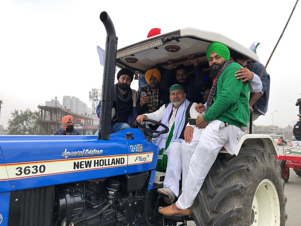 Rakesh Tikait (in the driver’s seat) participates in the tractor rally.